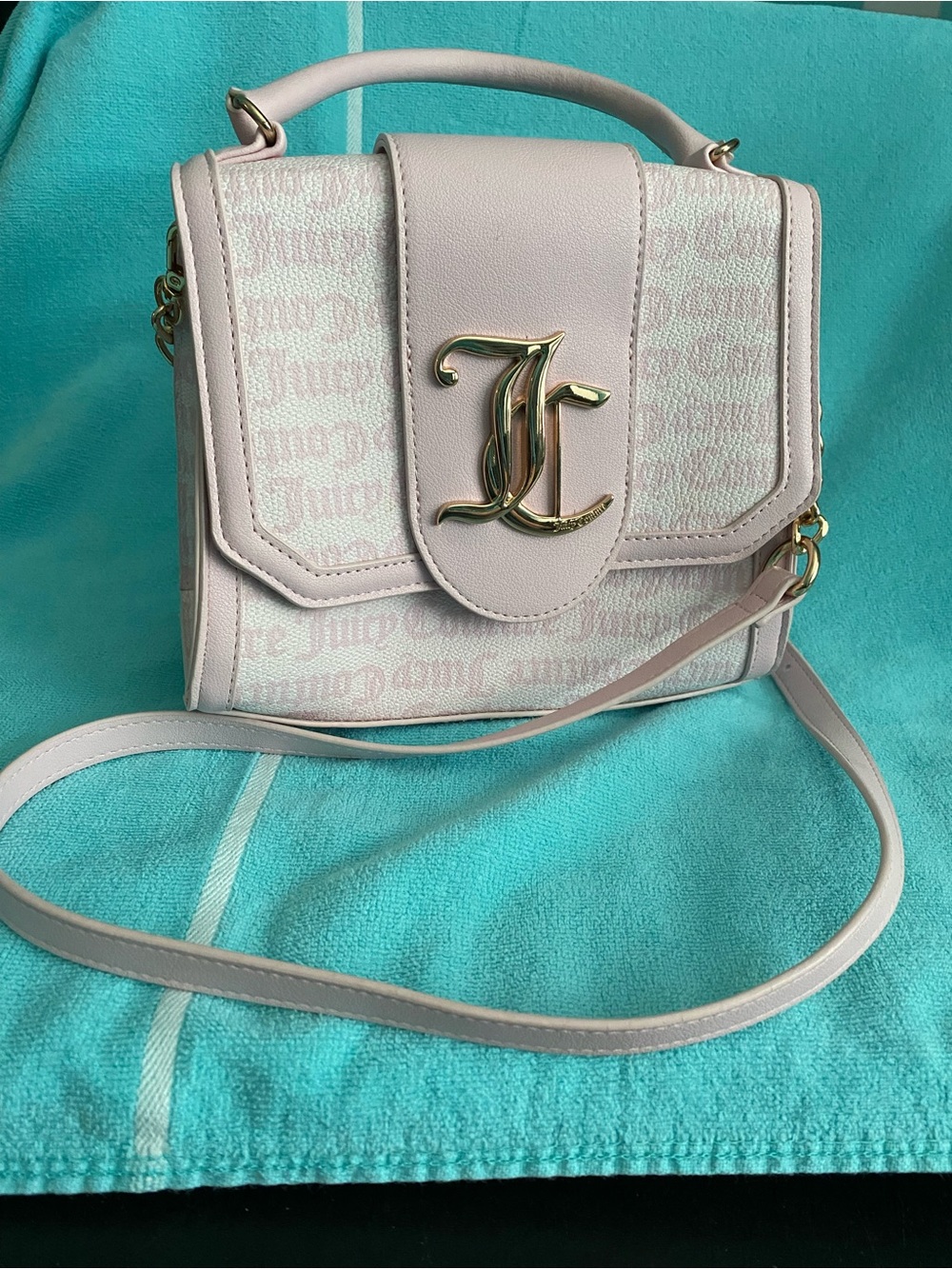 Juicy Couture, pink & white handbag with shoulder strap  JC initial front flap